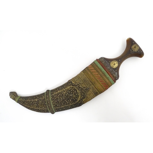 1071 - A 19thC Eastern Jambiya / Khanjar knife, the ram's horn hilt with two coins retaining the tang of th... 