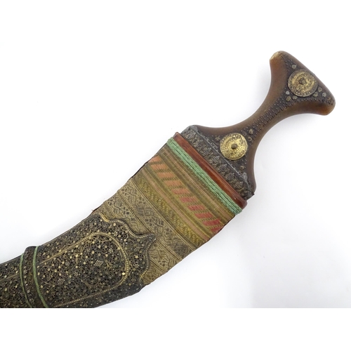 1071 - A 19thC Eastern Jambiya / Khanjar knife, the ram's horn hilt with two coins retaining the tang of th... 