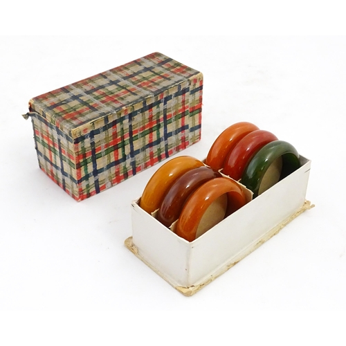 1083 - Six 20thC phenolic Bakelite style napkin rings. Approx. 1 3/4