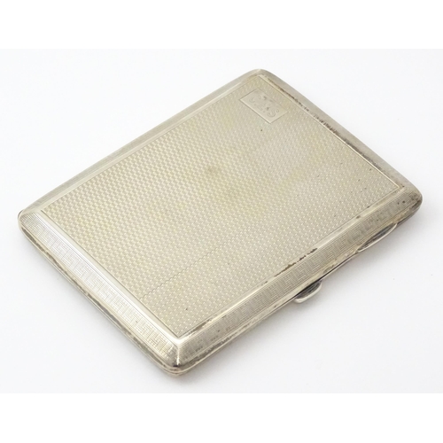 240 - A silver card case  with engine turned decoration  and Greek key borders. Hallmarked Birmingham 1928... 