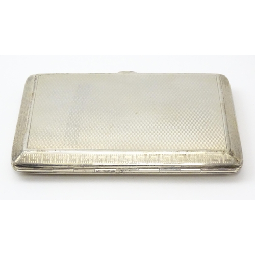 240 - A silver card case  with engine turned decoration  and Greek key borders. Hallmarked Birmingham 1928... 