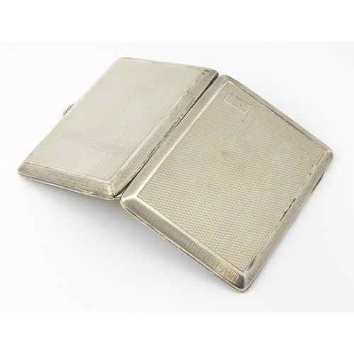 240 - A silver card case  with engine turned decoration  and Greek key borders. Hallmarked Birmingham 1928... 