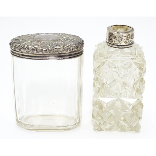 284 - A cut glass scent / perfume flask with silver mounts hallmarked London 1901.  Together with a panel ... 