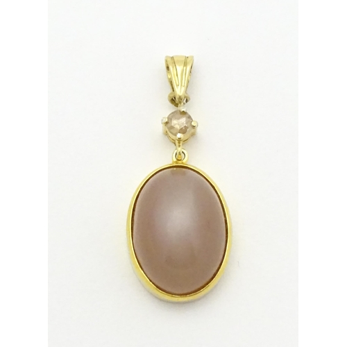 752 - A yellow metal pendant set with pink cabochon and diamond . Approx. 1 1/2