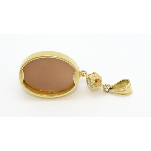 752 - A yellow metal pendant set with pink cabochon and diamond . Approx. 1 1/2