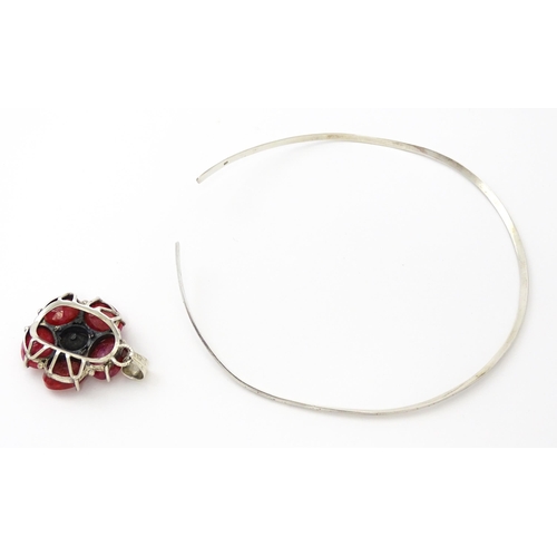 753 - A silver necklace of choker form with rose formed pendant set with red stones. The pendant approx 1 ... 