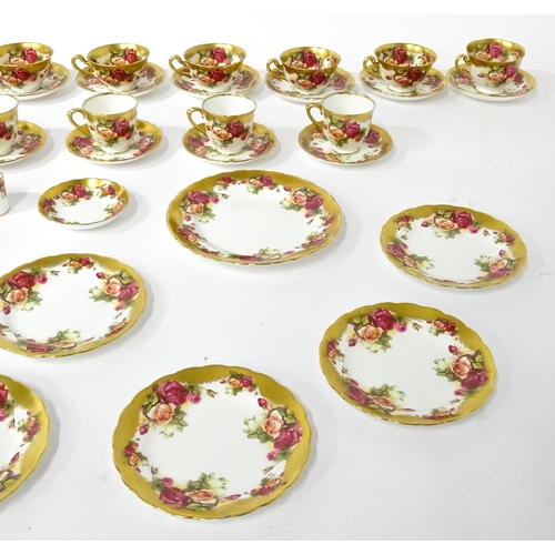 167 - A quantity of Royal Chelsea tea / coffee wares in the Golden Rose pattern to include cups, saucers, ... 