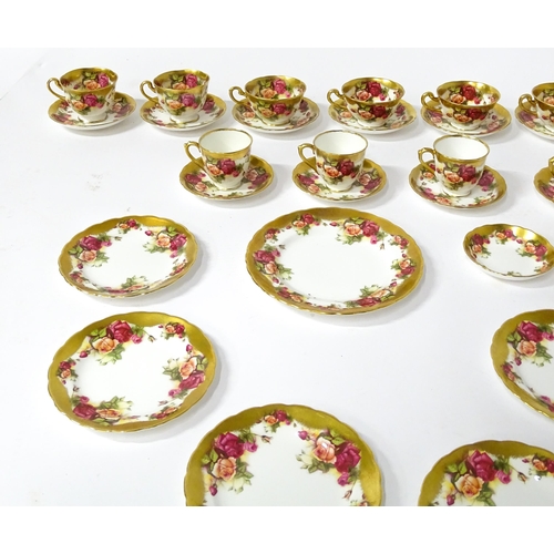 167 - A quantity of Royal Chelsea tea / coffee wares in the Golden Rose pattern to include cups, saucers, ... 