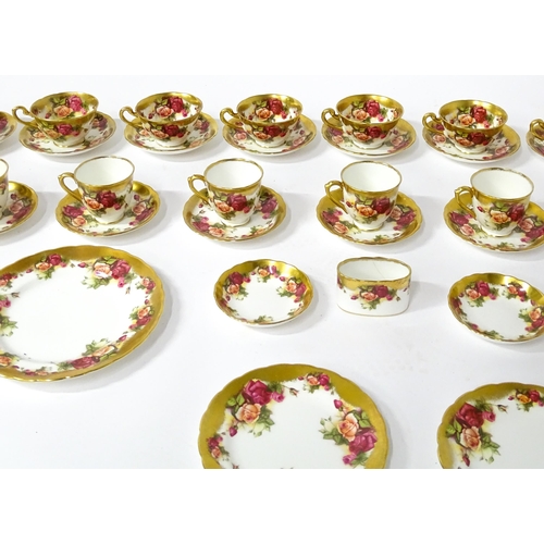 167 - A quantity of Royal Chelsea tea / coffee wares in the Golden Rose pattern to include cups, saucers, ... 