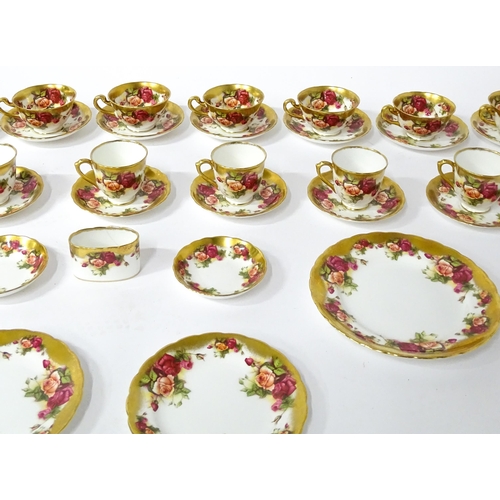 167 - A quantity of Royal Chelsea tea / coffee wares in the Golden Rose pattern to include cups, saucers, ... 