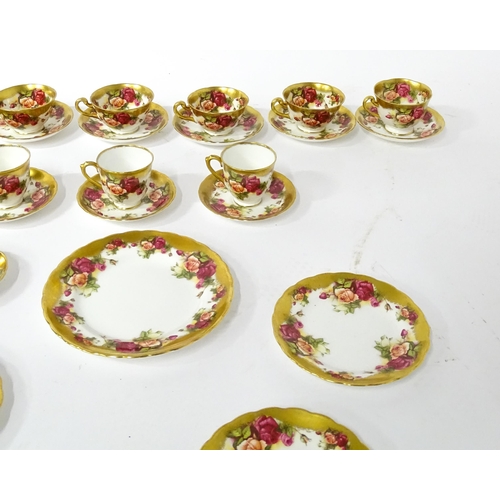 167 - A quantity of Royal Chelsea tea / coffee wares in the Golden Rose pattern to include cups, saucers, ... 