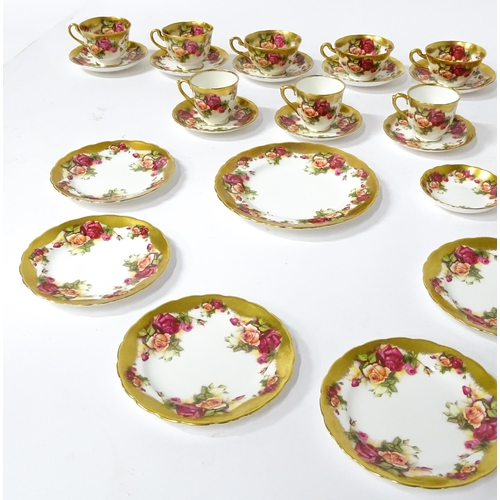 167 - A quantity of Royal Chelsea tea / coffee wares in the Golden Rose pattern to include cups, saucers, ... 