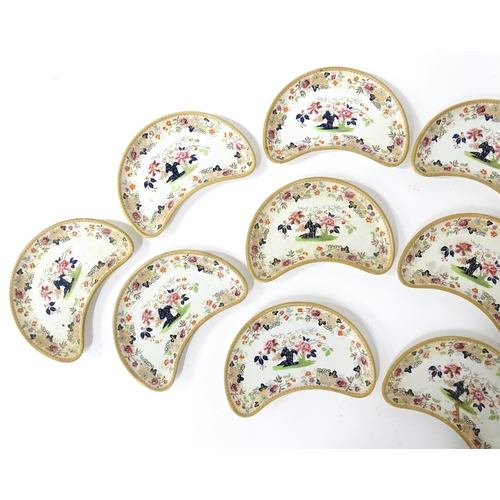 79 - Twelve Davenport crescent shaped salad dishes with floral and foliate decoration. Marked under. Appr... 