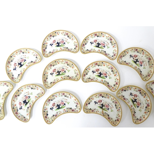 79 - Twelve Davenport crescent shaped salad dishes with floral and foliate decoration. Marked under. Appr... 