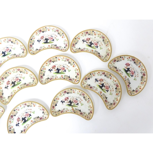 79 - Twelve Davenport crescent shaped salad dishes with floral and foliate decoration. Marked under. Appr... 