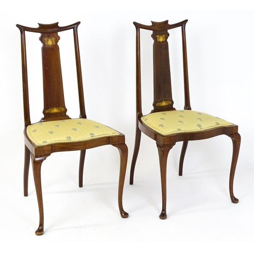 1439 - A pair of early 20thC Arts & Crafts style chairs with shaped top rails above tapering back splats se... 