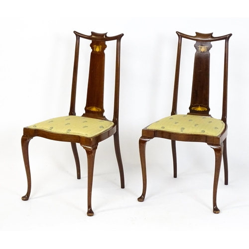 1439 - A pair of early 20thC Arts & Crafts style chairs with shaped top rails above tapering back splats se... 