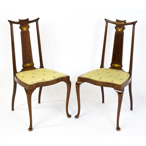 1439 - A pair of early 20thC Arts & Crafts style chairs with shaped top rails above tapering back splats se... 