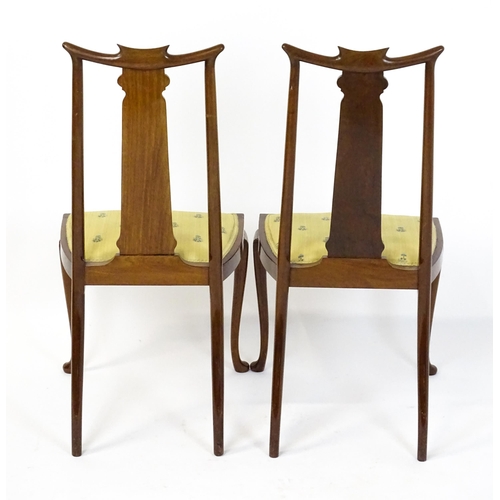 1439 - A pair of early 20thC Arts & Crafts style chairs with shaped top rails above tapering back splats se... 