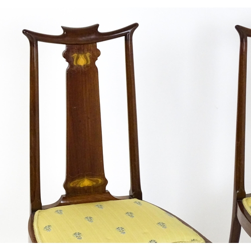 1439 - A pair of early 20thC Arts & Crafts style chairs with shaped top rails above tapering back splats se... 