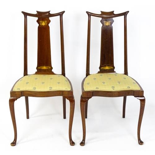 1439 - A pair of early 20thC Arts & Crafts style chairs with shaped top rails above tapering back splats se... 