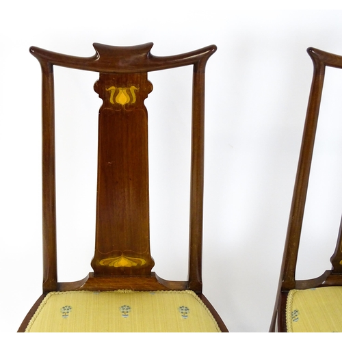 1439 - A pair of early 20thC Arts & Crafts style chairs with shaped top rails above tapering back splats se... 