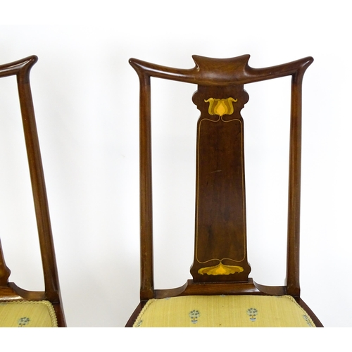 1439 - A pair of early 20thC Arts & Crafts style chairs with shaped top rails above tapering back splats se... 