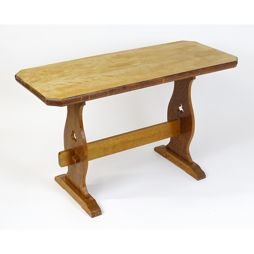 1441 - An early 20thC oak trestle table with a canted table top above two pieced platforms united by a rect... 