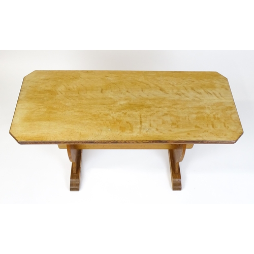 1441 - An early 20thC oak trestle table with a canted table top above two pieced platforms united by a rect... 