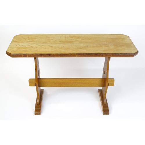 1441 - An early 20thC oak trestle table with a canted table top above two pieced platforms united by a rect... 