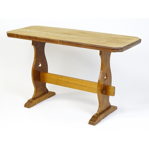 1441 - An early 20thC oak trestle table with a canted table top above two pieced platforms united by a rect... 