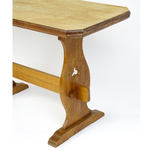 1441 - An early 20thC oak trestle table with a canted table top above two pieced platforms united by a rect... 