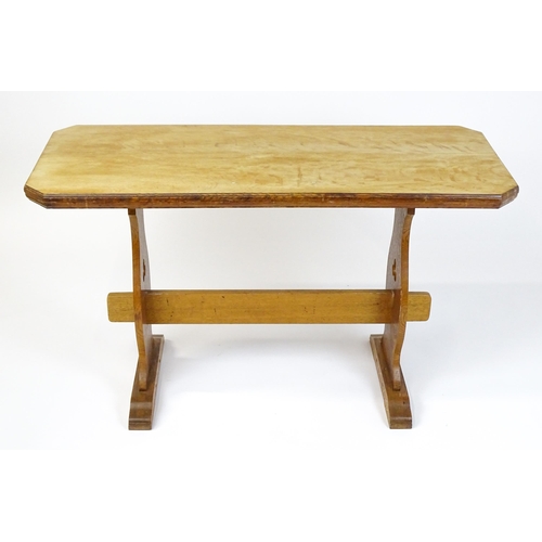 1441 - An early 20thC oak trestle table with a canted table top above two pieced platforms united by a rect... 