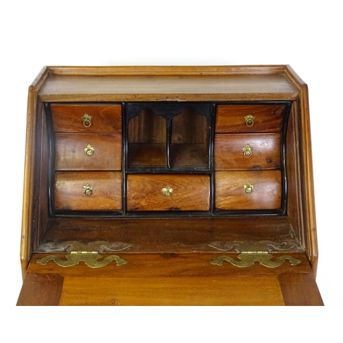 1442 - A 20thC Anglo - Indian bureau on stand with a fall front opening to show fitted drawers and pigeon h... 