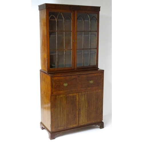 1443 - An early 19thC mahogany secretaire bookcase with an astragal glazed bookcase above a single secretai... 