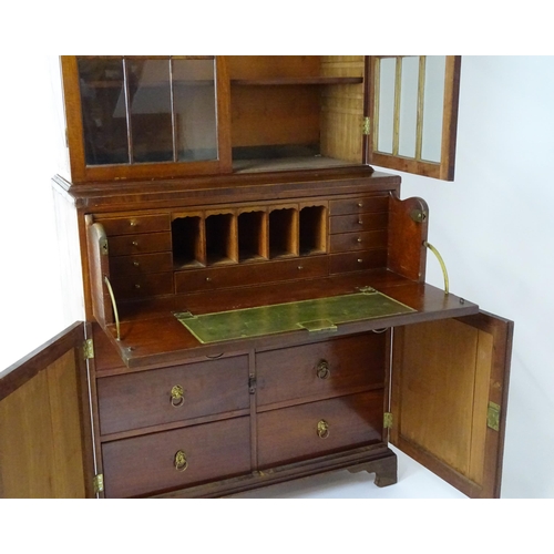 1443 - An early 19thC mahogany secretaire bookcase with an astragal glazed bookcase above a single secretai... 