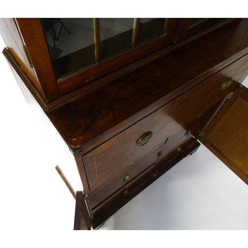 1443 - An early 19thC mahogany secretaire bookcase with an astragal glazed bookcase above a single secretai... 