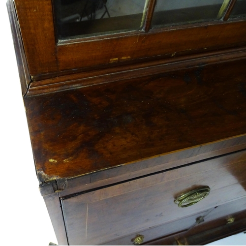 1443 - An early 19thC mahogany secretaire bookcase with an astragal glazed bookcase above a single secretai... 