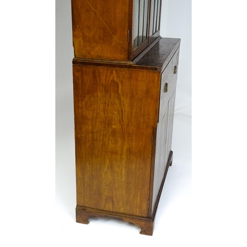 1443 - An early 19thC mahogany secretaire bookcase with an astragal glazed bookcase above a single secretai... 