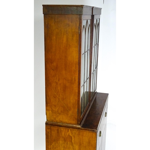 1443 - An early 19thC mahogany secretaire bookcase with an astragal glazed bookcase above a single secretai... 