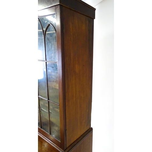 1443 - An early 19thC mahogany secretaire bookcase with an astragal glazed bookcase above a single secretai... 