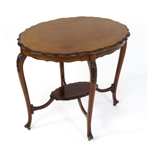 1472 - An Edwardian mahogany occasional table with a shaped inlaid top above four carved cabriole legs unit... 