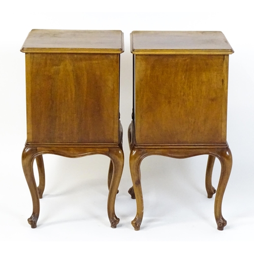 1474 - A pair of early / mid 20thC walnut bedside cabinets, each having a single short drawer, panelled cup... 