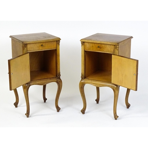 1474 - A pair of early / mid 20thC walnut bedside cabinets, each having a single short drawer, panelled cup... 