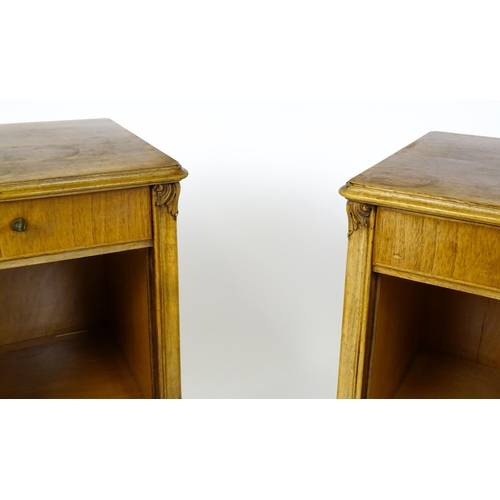 1474 - A pair of early / mid 20thC walnut bedside cabinets, each having a single short drawer, panelled cup... 