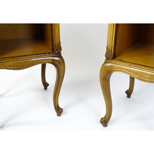 1474 - A pair of early / mid 20thC walnut bedside cabinets, each having a single short drawer, panelled cup... 