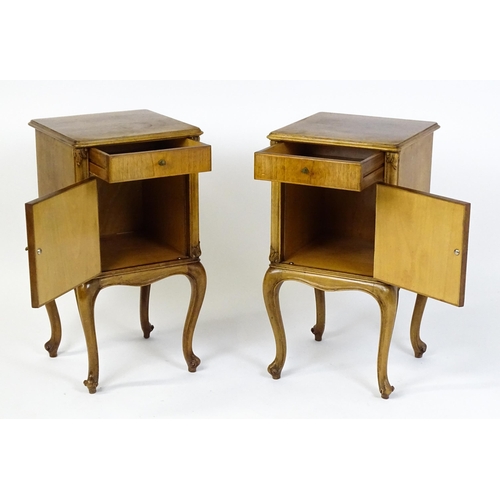 1474 - A pair of early / mid 20thC walnut bedside cabinets, each having a single short drawer, panelled cup... 