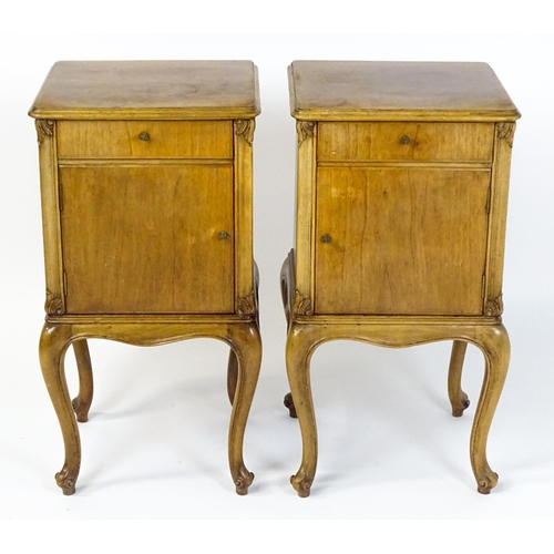 1474 - A pair of early / mid 20thC walnut bedside cabinets, each having a single short drawer, panelled cup... 