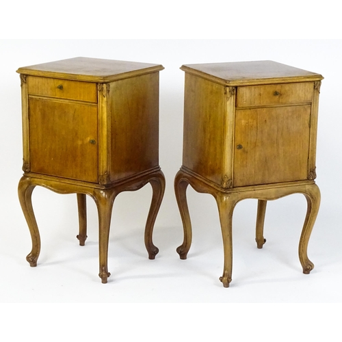 1474 - A pair of early / mid 20thC walnut bedside cabinets, each having a single short drawer, panelled cup... 