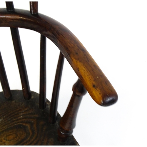 1475 - A 19thC child's yew wood Windsor chair by George Nicholson of Rockley, the chair having a pierced ba... 